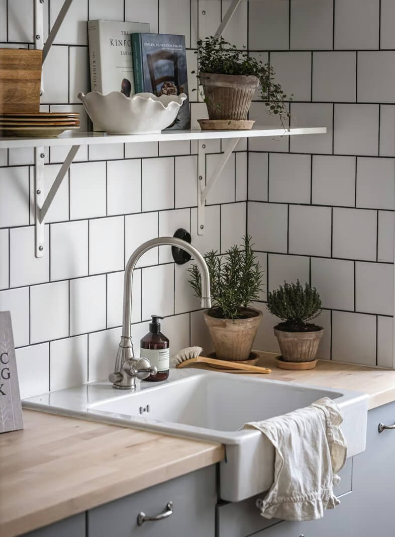 A Beige Studio Apartment with a Bright Kitchen 9 kitchen detail butler sink and shelf