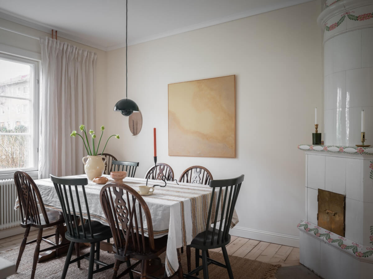 A Carefully Renovated Family Home in Sweden 15 kitchen dining table and fireplace