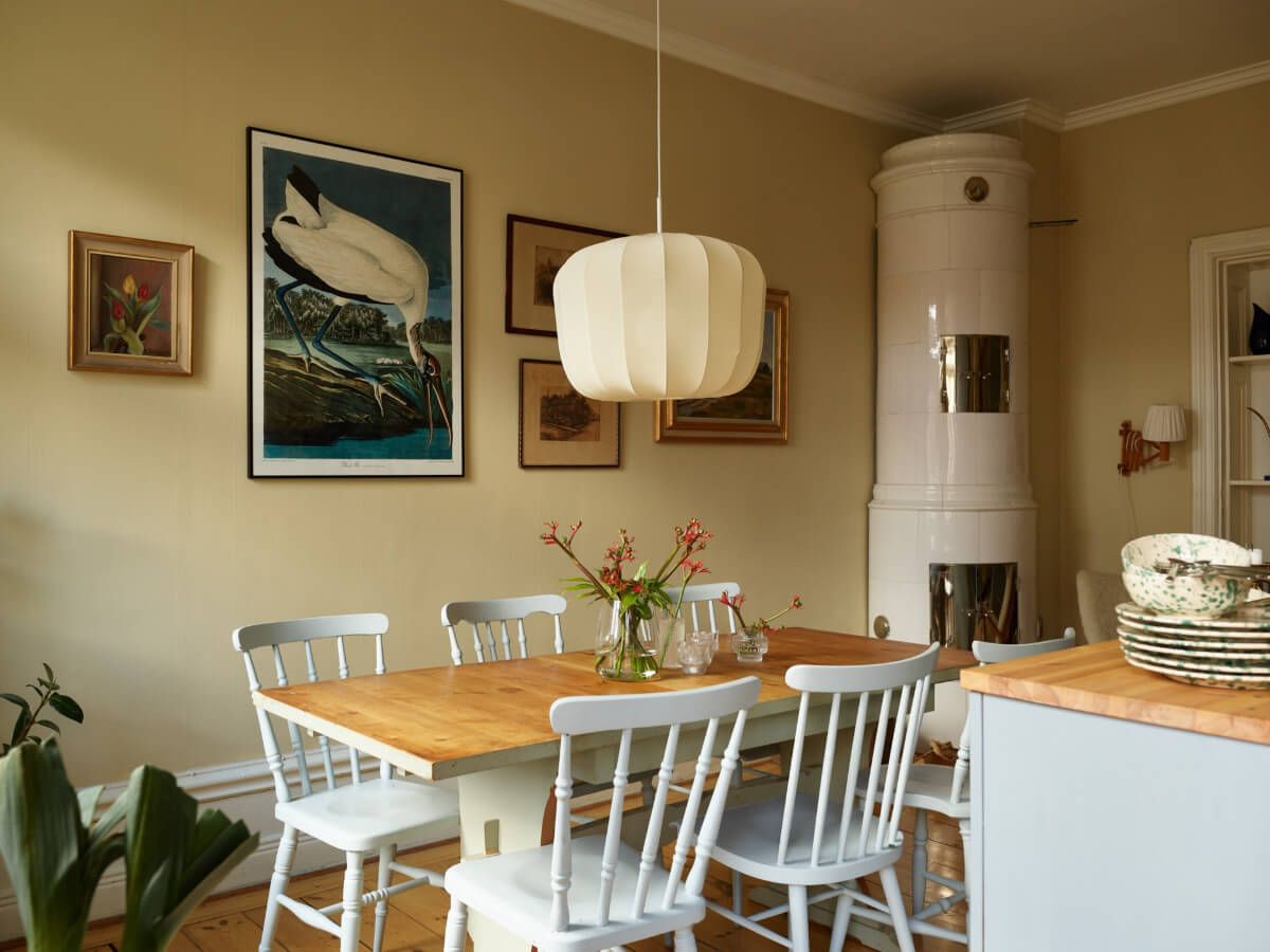 A Charming Historic Stockholm Apartment with a Blue Kitchen 10 kitchen dining table pastel blue chairs