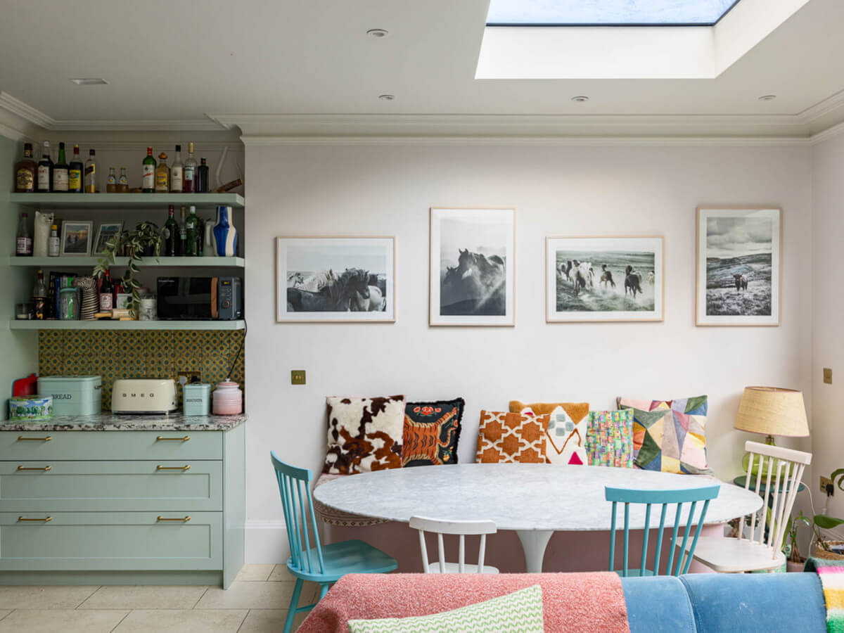 An Extended Family Home in London with Pink Crittall Doors 7 kitchen dining table with bench