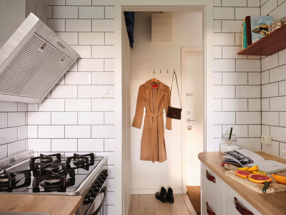 A Small Stockholm Apartment with a Tiny Green Bedroom 17 kitchen doorway to hall