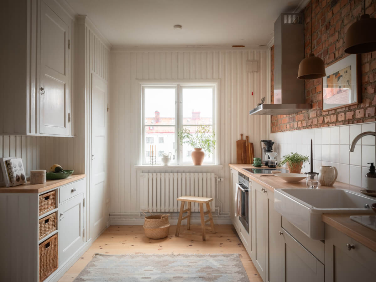 A Renovated Duplex Apartment with Exposed Brick Walls 6 kitchen gray cabinets exposed brick wall nordroom