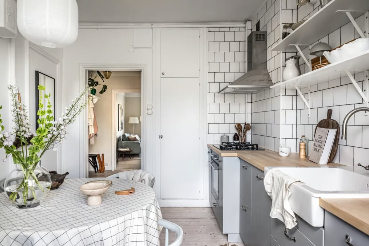 A Beige Studio Apartment with a Bright Kitchen 11 kitchen gray cabinets round table