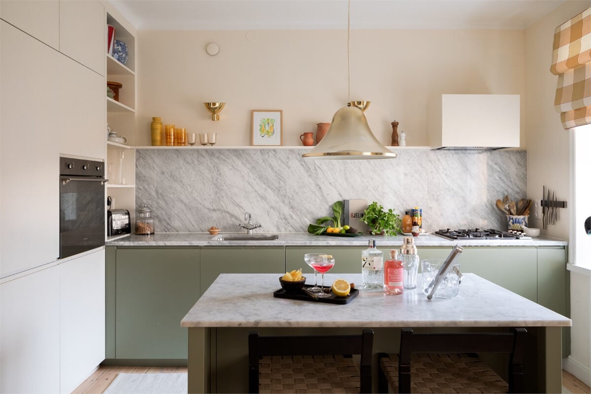 A Light-Filled Two Bedroom Apartment in Stockholm 6 kitchen green cabinets marble worktop