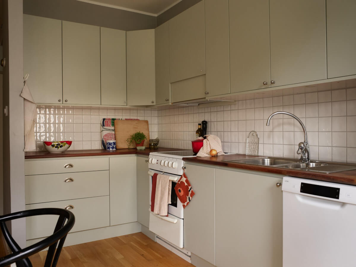 A Charming Two-Bedroom Corner Apartment in a 1940s Building 11 kitchen light green cupboards