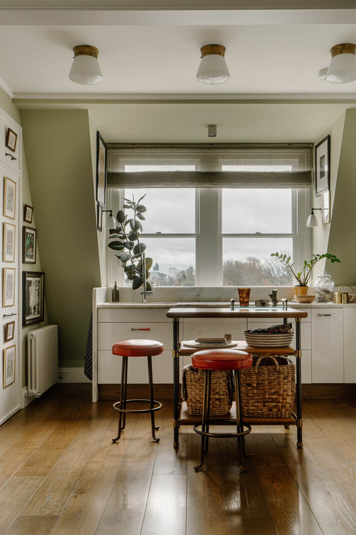 A Cozy Art-Filled Attic Apartment in London 12 kitchen slanted walls gallery wall