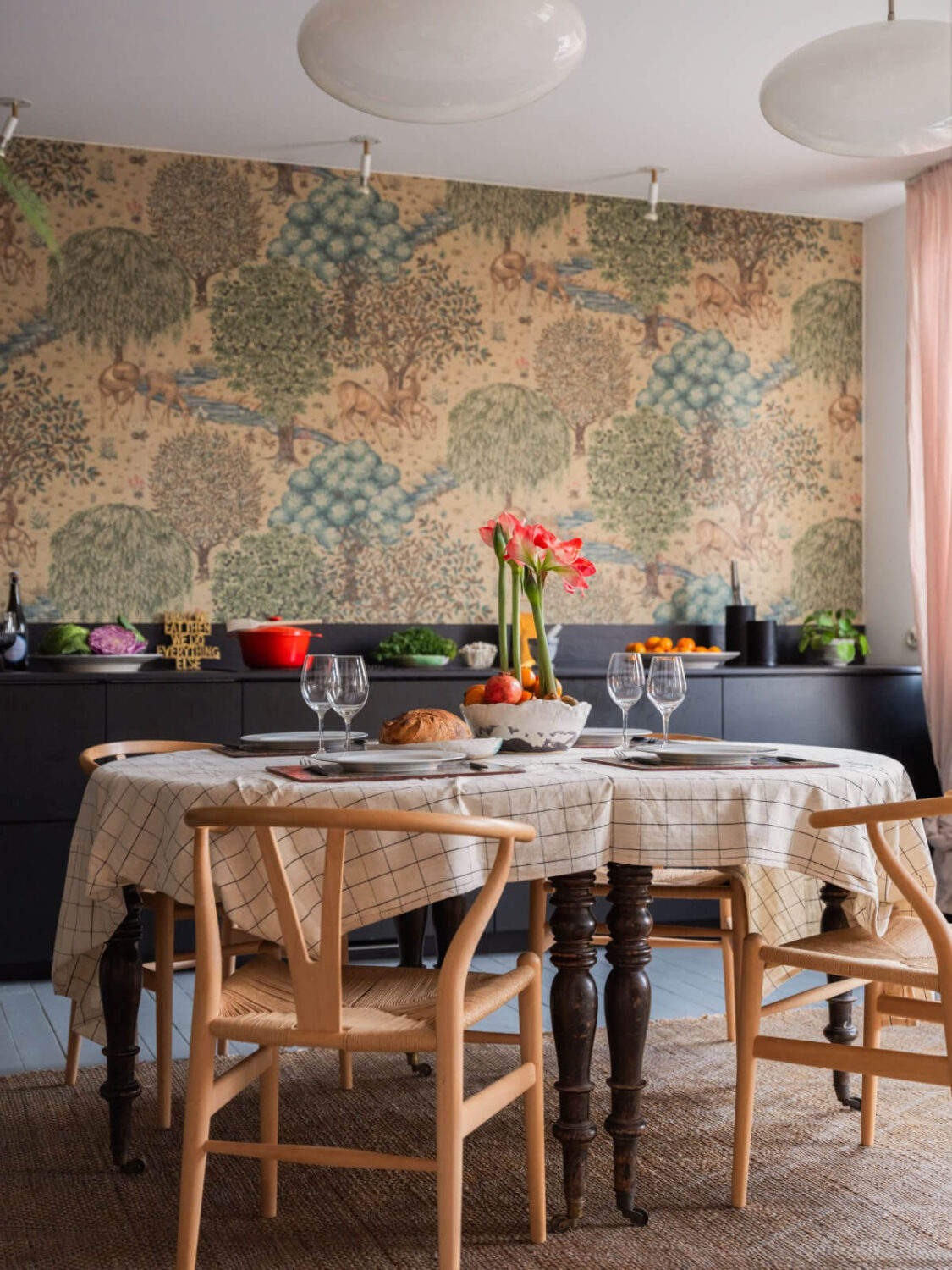 Painted Floorboards in a Unique Family Home in Sweden 7 kitchen sleek black cabinets and william morris wallpaper
