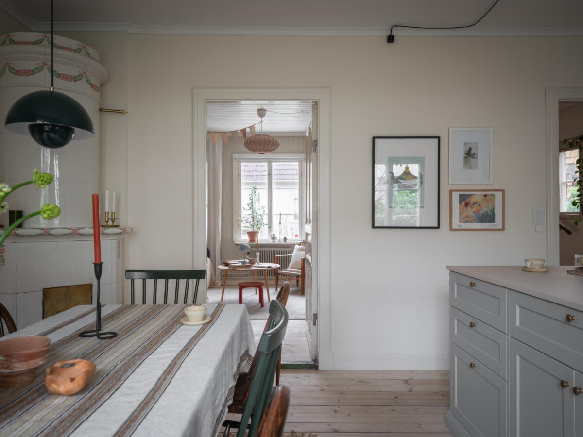 A Carefully Renovated Family Home in Sweden 17 kitchen space with dining table and fireplace