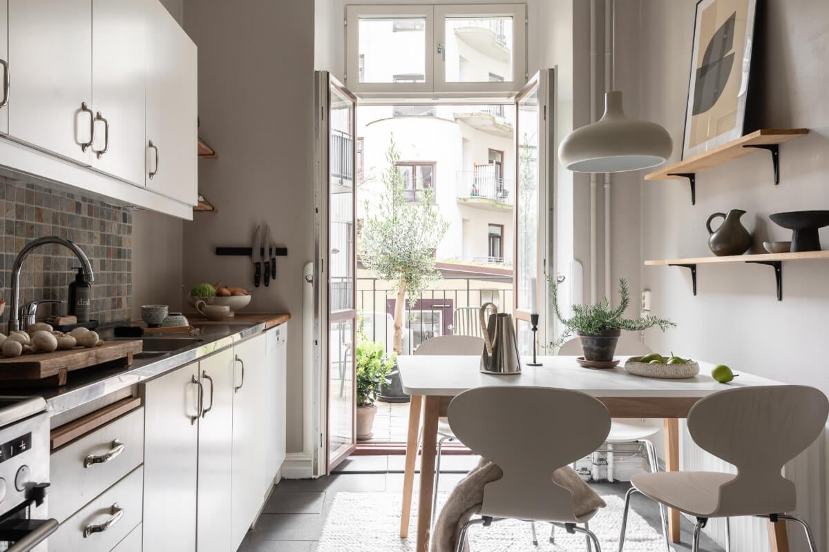 A Serene Studio Apartment with a Loft Bed and a Large Balcony 11 kitchen stone floor light gray walls balcony