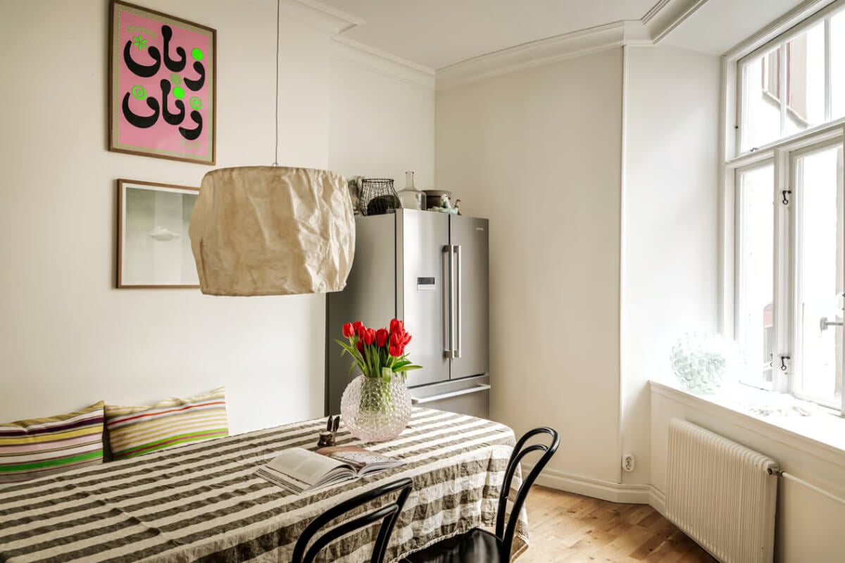 Large Rooms in an Art Nouveau Apartment in Sweden 12 kitchen table striped table cloth