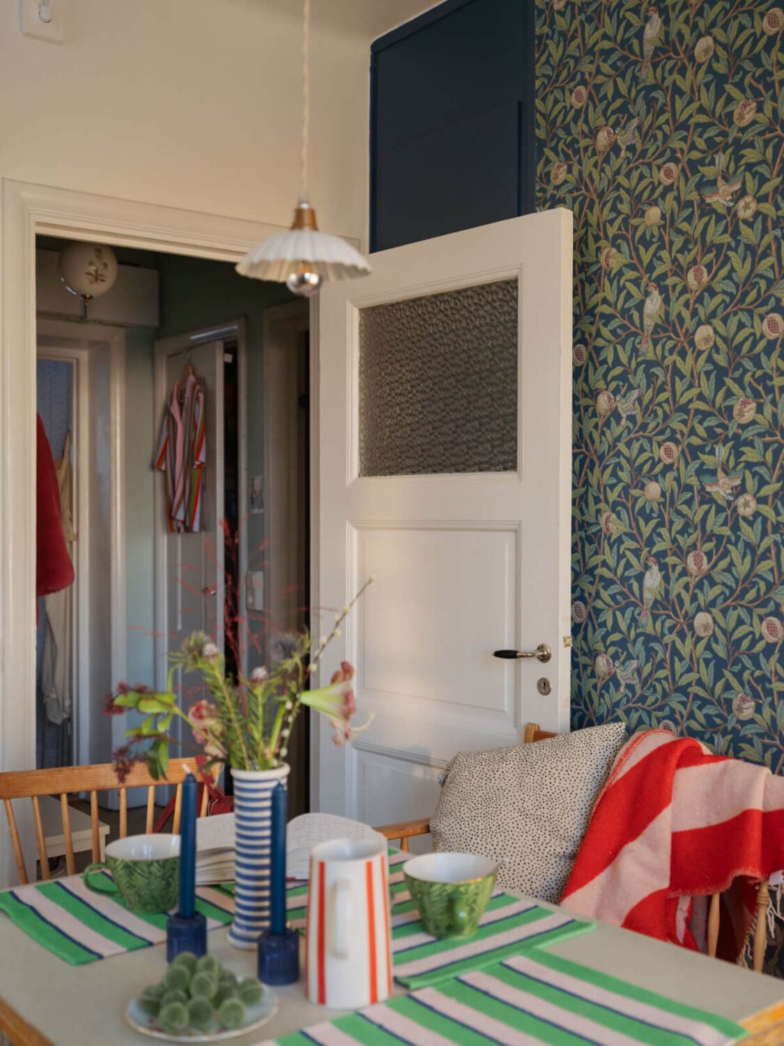 A Charming and Light-Filled Studio Apartment in Stockholm 17 kitchen table with frilly pendant