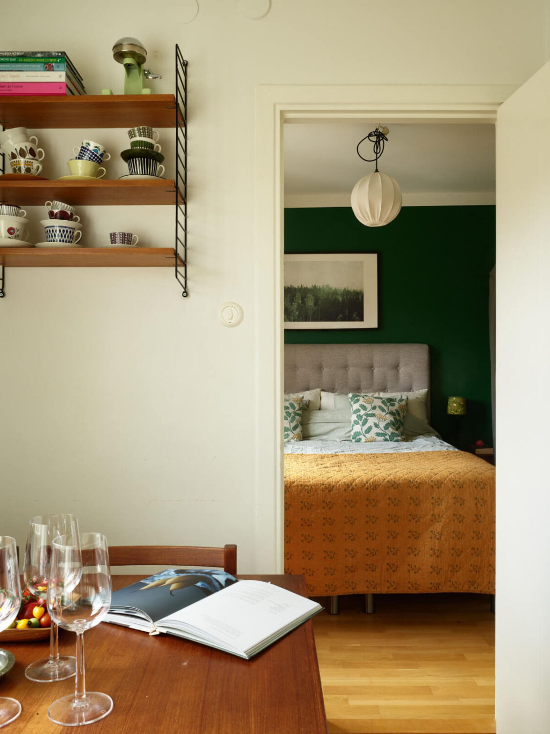 A Charming Midcentury Apartment with Original Features 16 kitchen view into green bedroom
