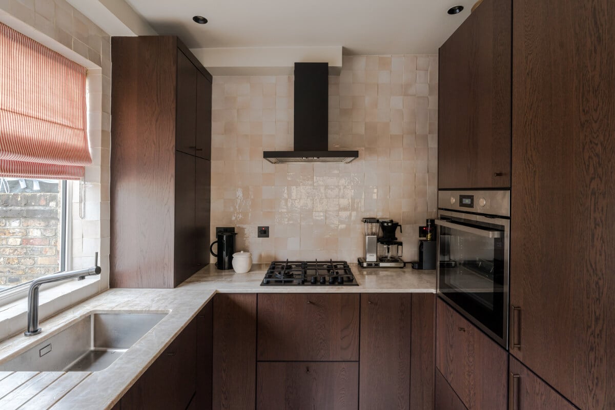 Cozy Contemporary Spaces in a Light-Filled Victorian Apartment 14 kitchen walnut cabinets pink zellige tiles backsplash