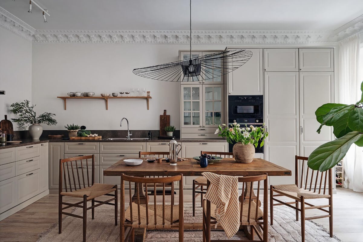 Warm and Inviting Rooms in a Renovated Swedish Apartment 11 kitchen warm beige cabinets wooden table