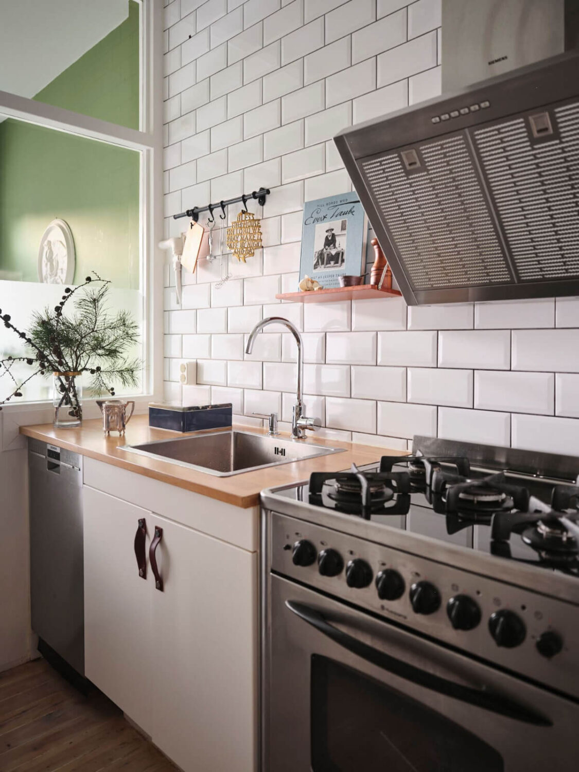 A Small Stockholm Apartment with a Tiny Green Bedroom 16 kitchen white backsplash tiles