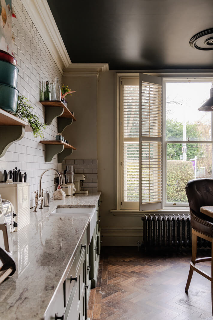 A Grand Victorian Villa in Manchester with Bold Interiors 9 kitchen white backsplash tiles large windows with shutters nordroom