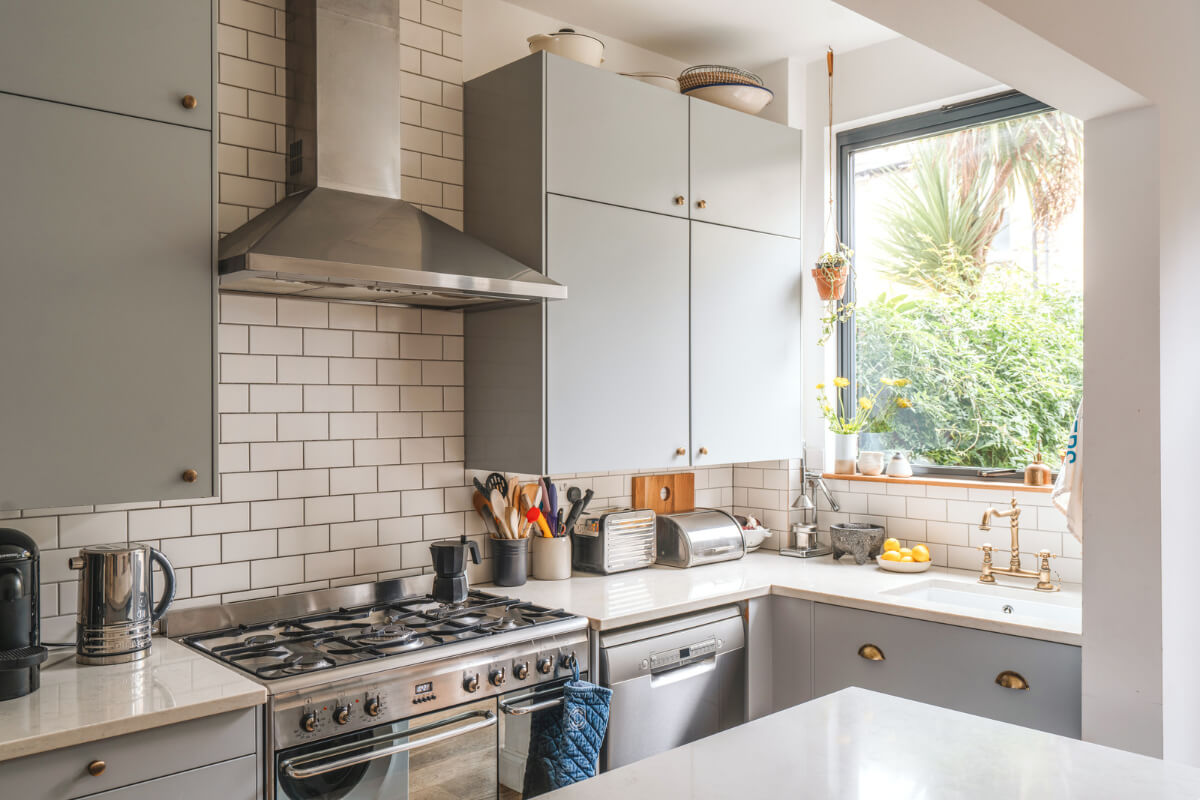 A Charming Light Edwardian House with a Tiny Garden 8 kitchen white subway tiles brass fittings