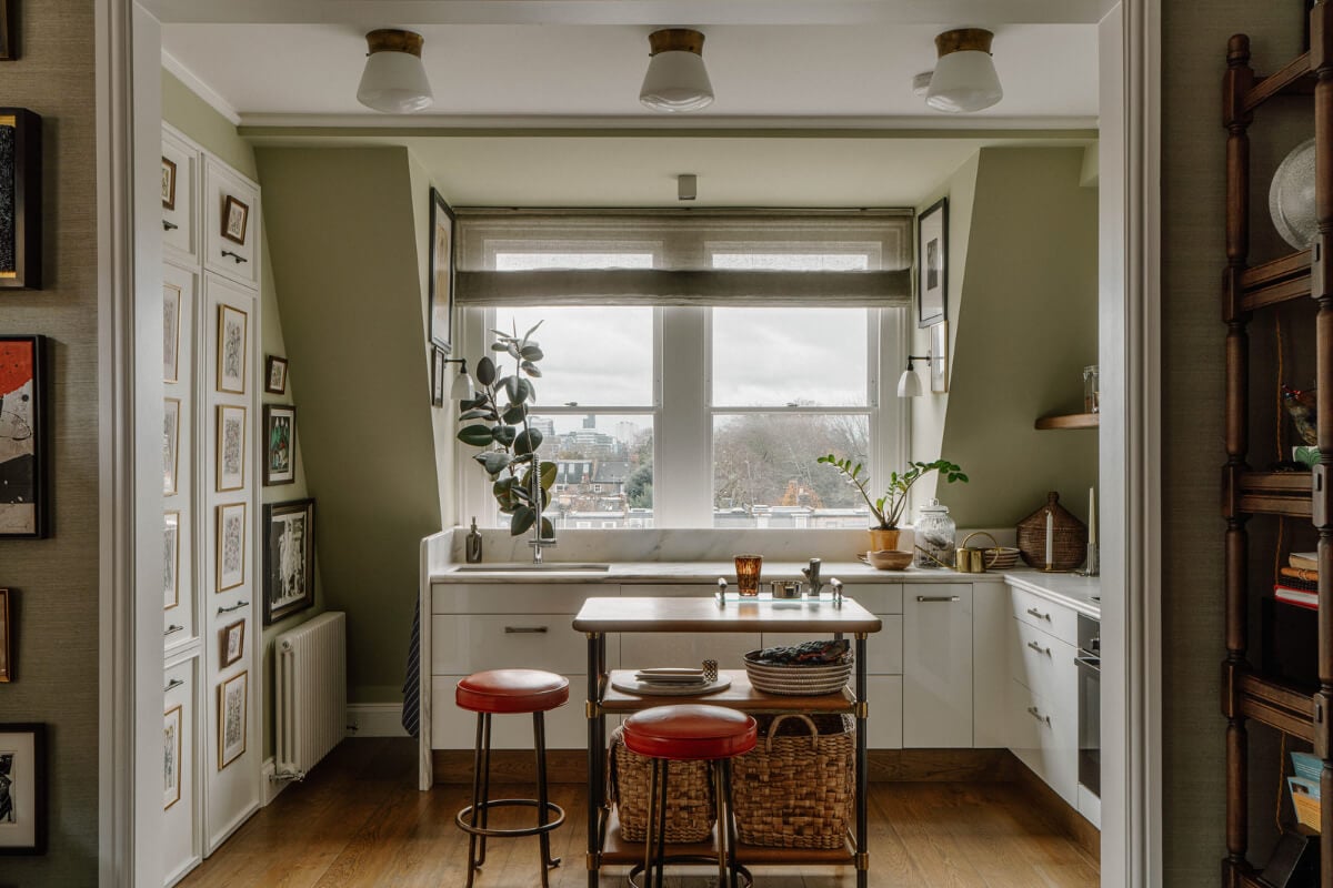 A Cozy Art-Filled Attic Apartment in London 8 kitchen with olive green slanted walls