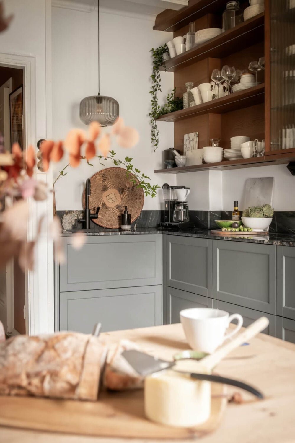 A Swedish Attic Apartment with Exposed Brick and Yellow Color Accents 9 kitchen with open and closed cabinets