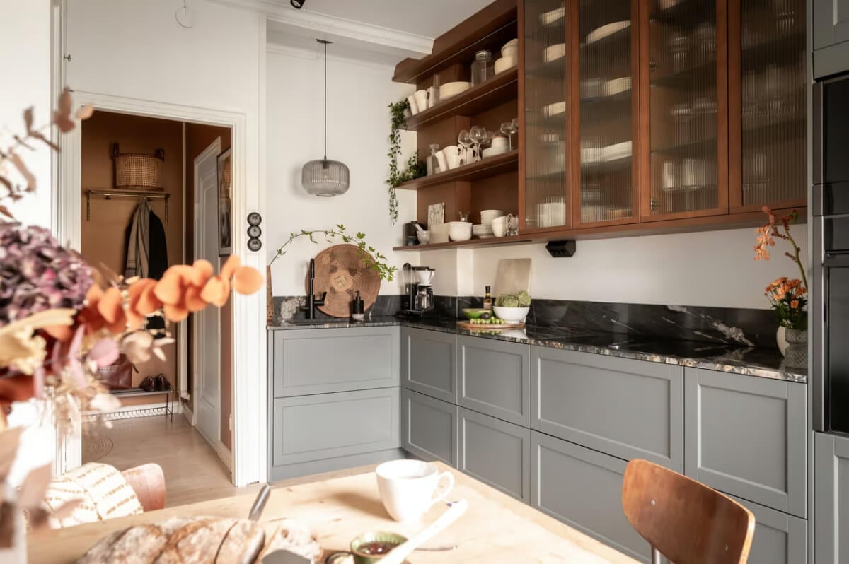 A Swedish Attic Apartment with Exposed Brick and Yellow Color Accents 7 kitchen with open and ribbed glass fronted cabinets