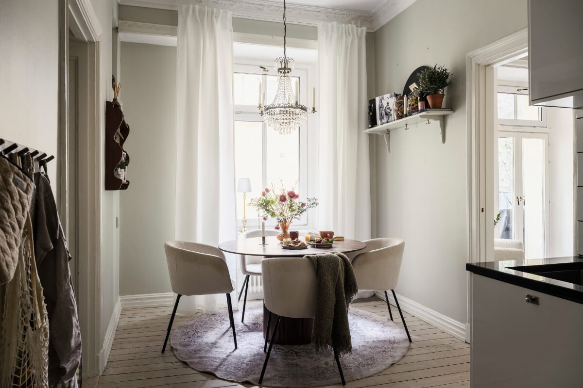Limewash Wall and Period Features in a Swedish Apartment 11 kitchen with round table large window