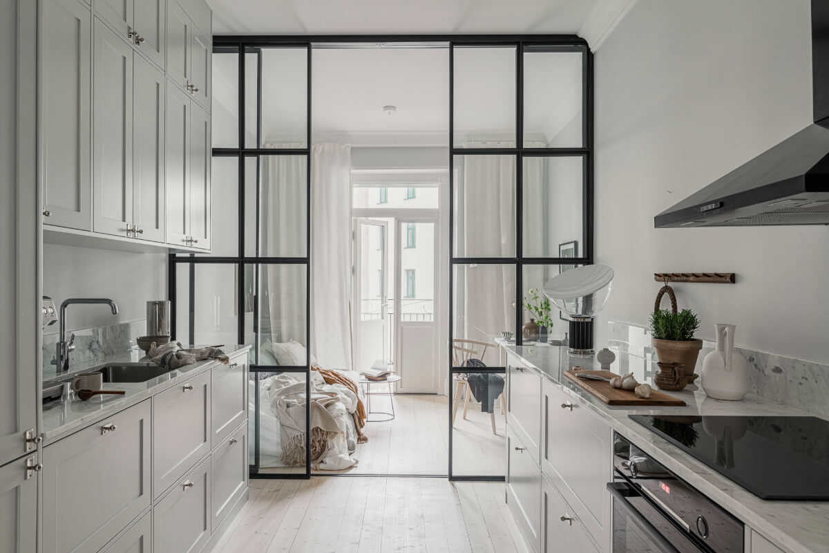 Period Features and Contemporary Solutions in Gothenburg 17 kitchen with steel framed glass sliding doors to bedroom