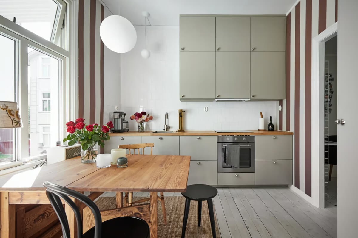 A Bright Turn-of-the-Century Apartment in Sweden 9 kitchen with wooden floor striped wallpaper