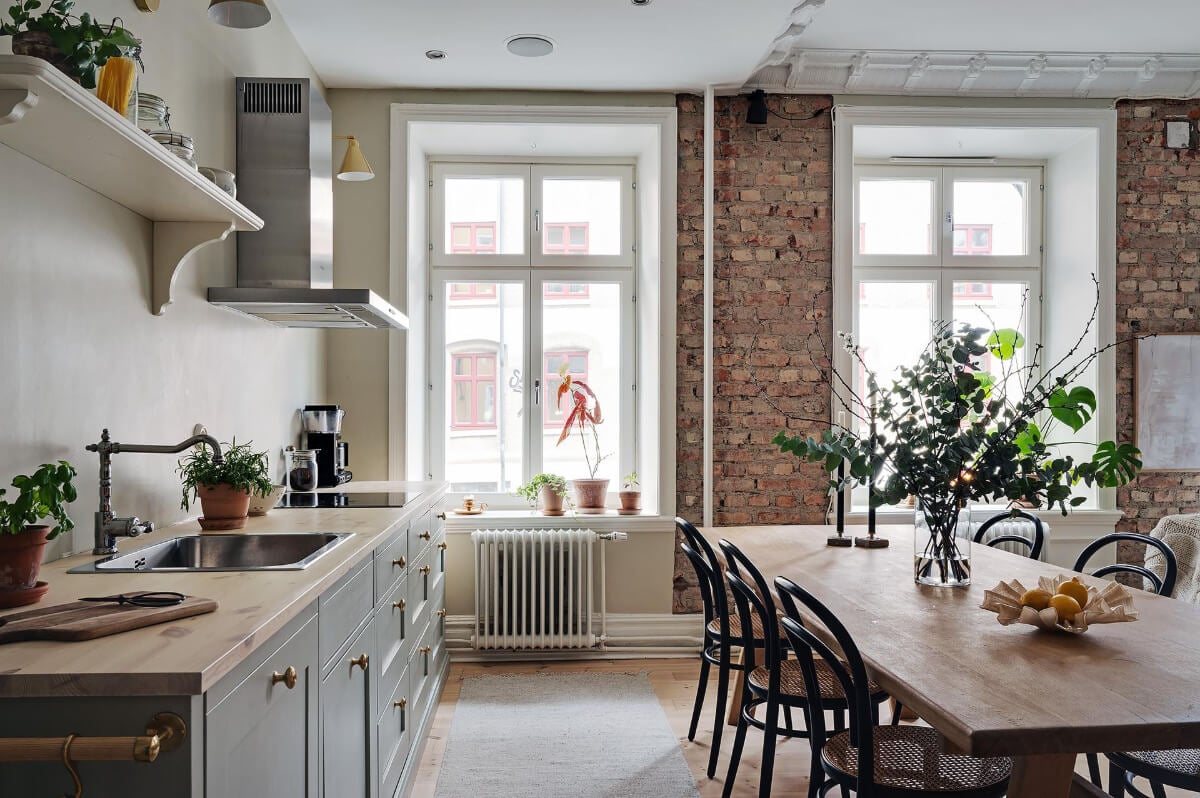 A Swedish Apartment with an Open Living Space and Period Features 11 kitchen without upper cabinets brick wall
