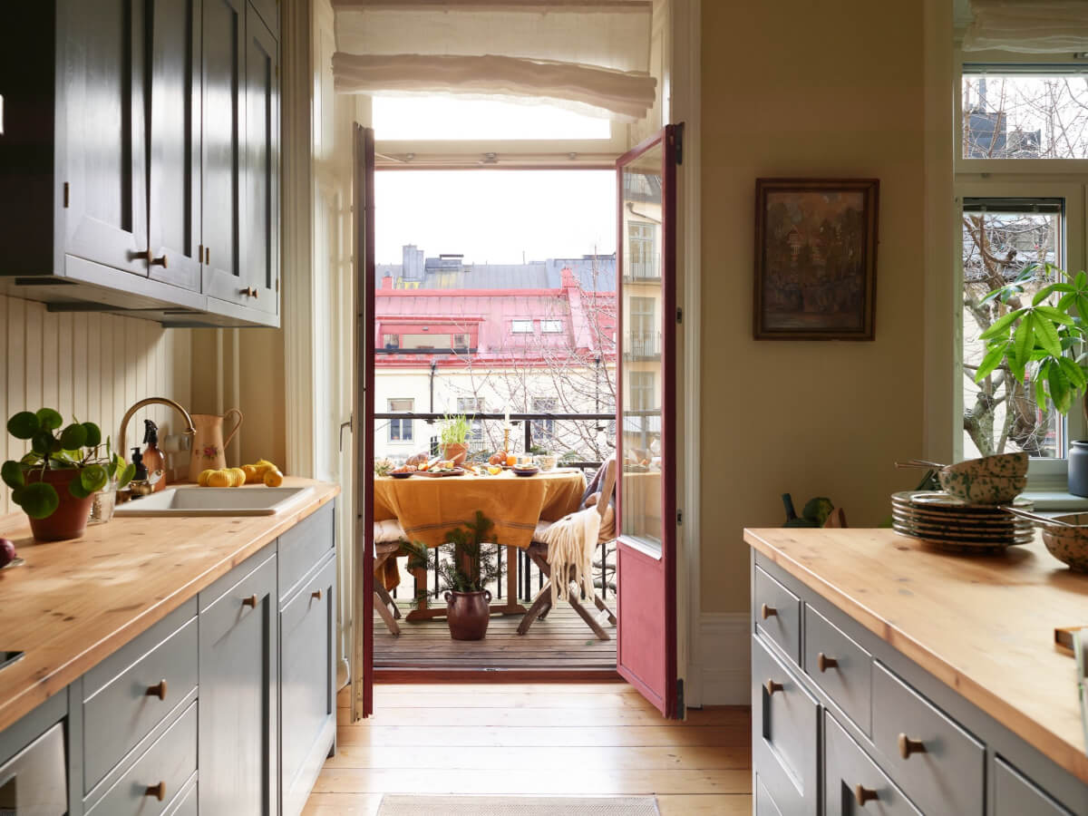 A Charming Historic Stockholm Apartment with a Blue Kitchen 2 kitchen wooden countertop balcony acces