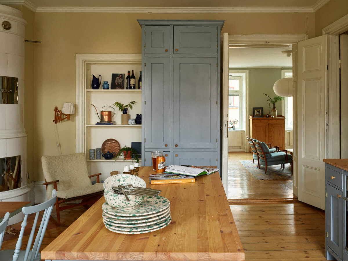 A Charming Historic Stockholm Apartment with a Blue Kitchen 7 kitchen wooden floorboards view to living room