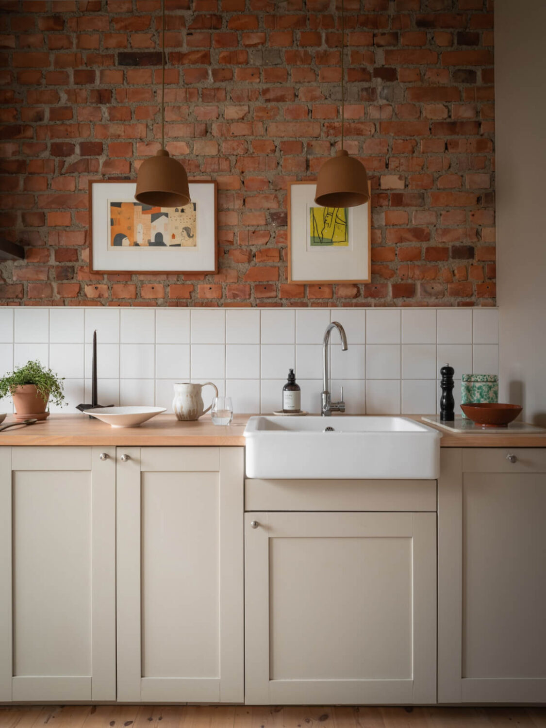 A Renovated Duplex Apartment with Exposed Brick Walls 10 kitchen wooden worktop butler sink exposed brick wall nordroom