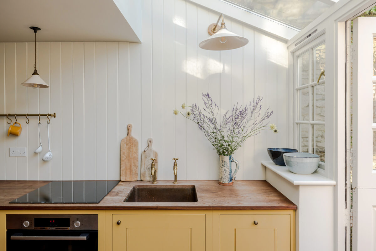 A Carefully Selected Color Palette in an 18th-Century English Cottage 6 kithcne with ochre yellow cabinets and wooden worktop
