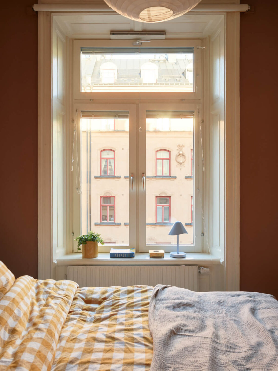 A Charming Historic Stockholm Apartment with a Blue Kitchen 23 large bedroom window deep window sill