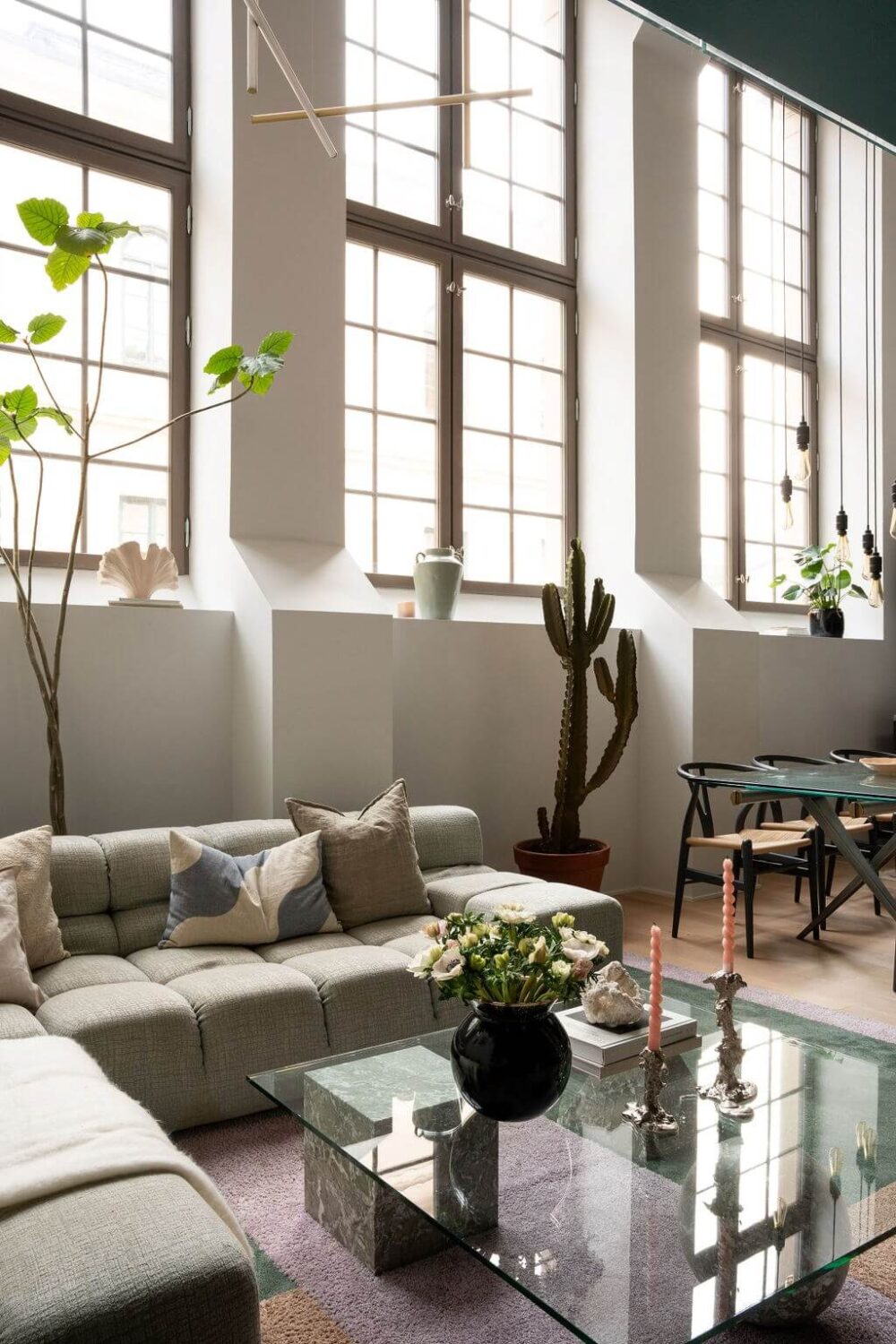 A Loft with High Ceilings and Large Windows in an Exclusive Stockholm Building 3 large industrial windows living room