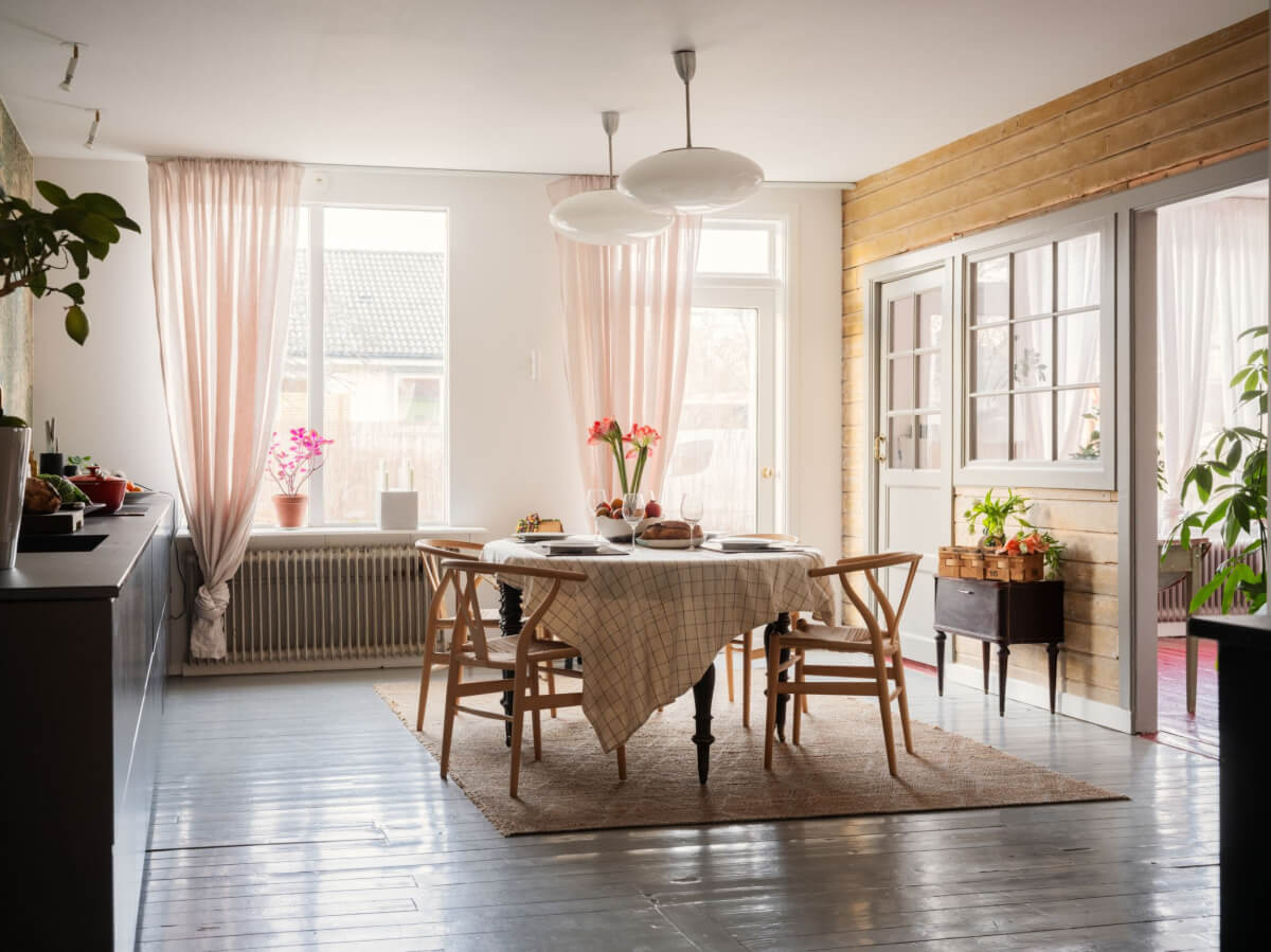 Painted Floorboards in a Unique Family Home in Sweden 8 large kitchen space with wooden accent wall and dining table