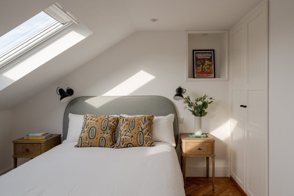 A Restored Victorian House with Exposed Brick and a Kitchen Extension 21 light attic bedroom gray headboard