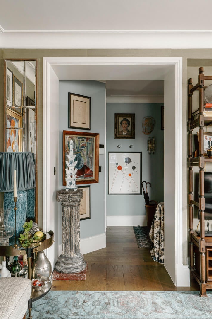 A Cozy Art-Filled Attic Apartment in London 20 light blue hall with art
