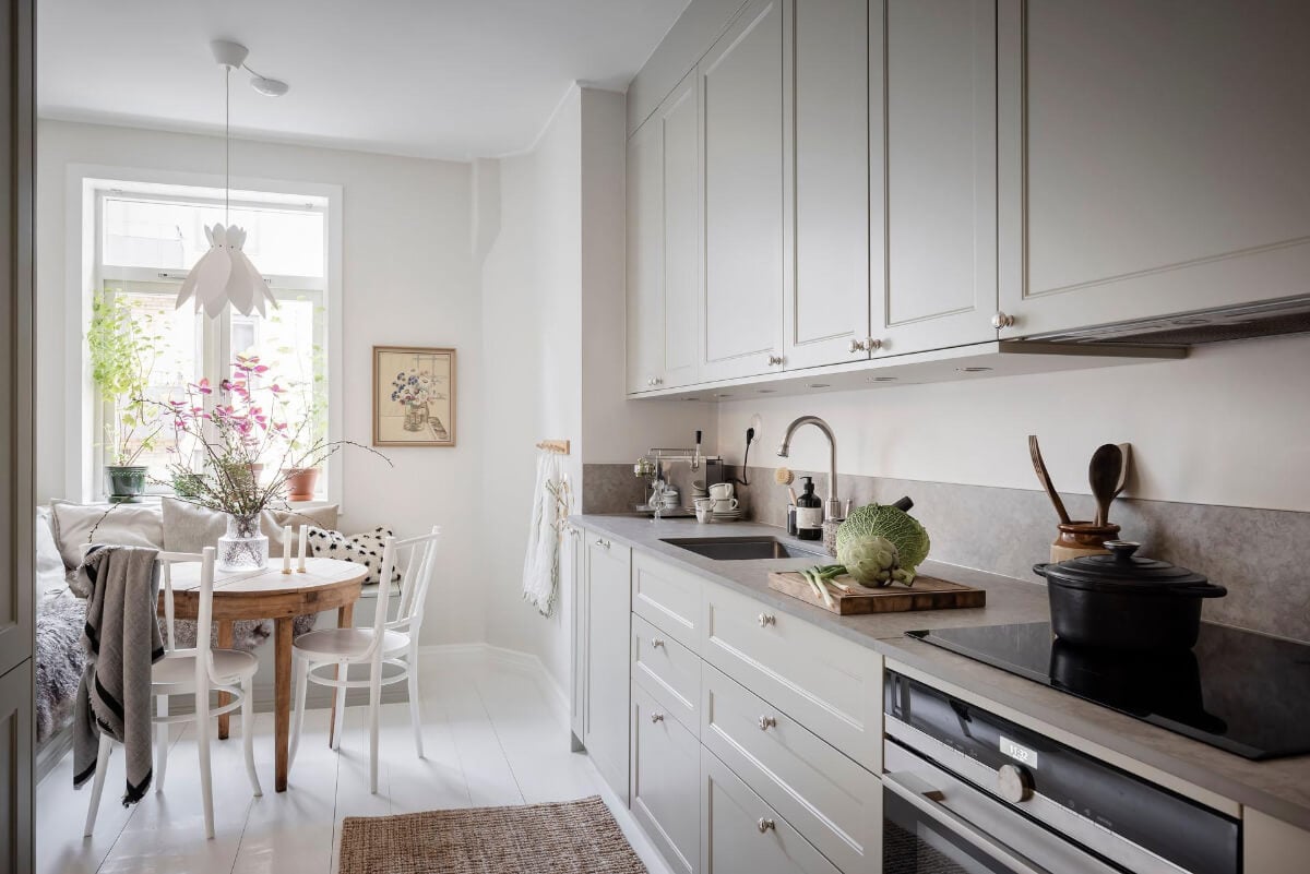 White-Painted Floorboards in a Turn-of-the-Century Apartment 11 light gray cabinets beakfast nook