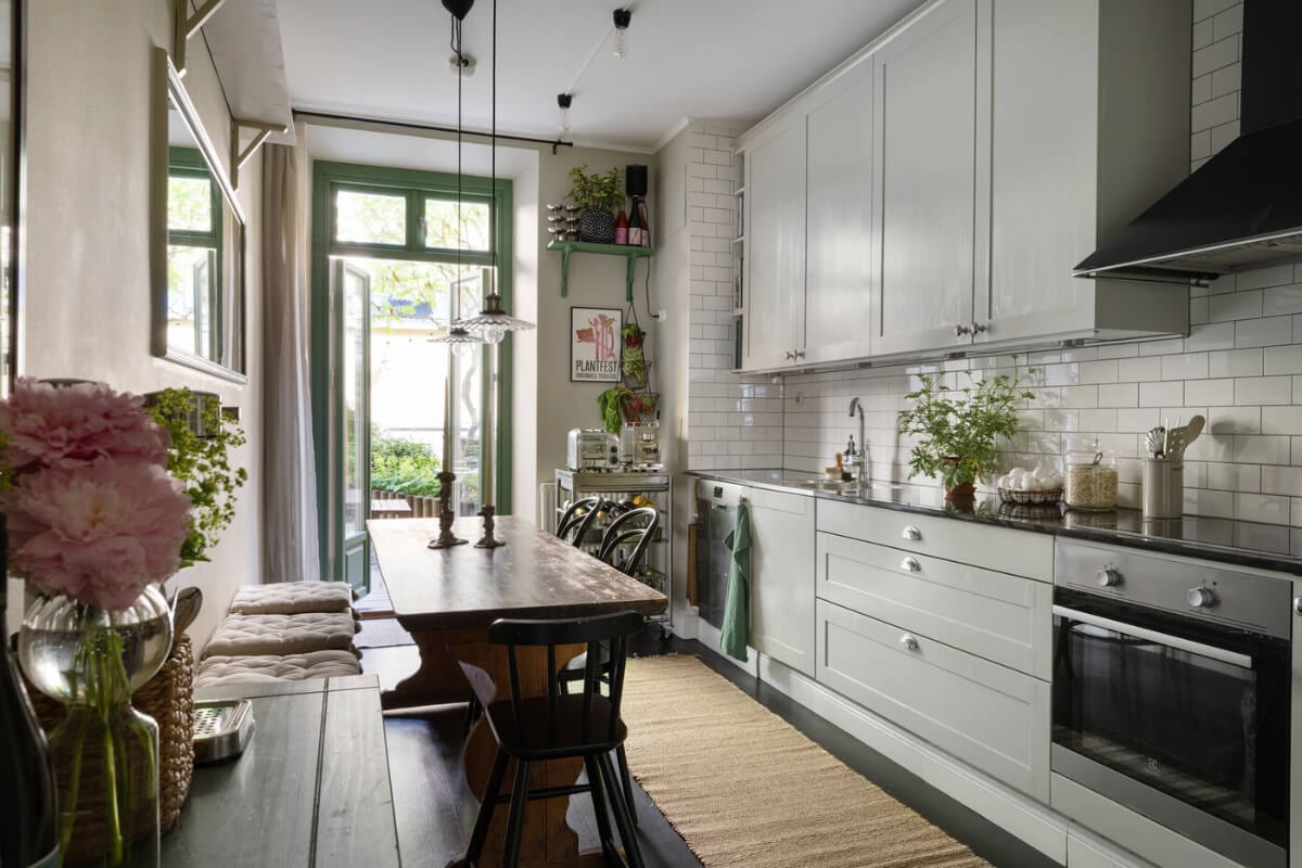 A Charming Ground Floor Apartment with a Large Patio Garden 7 light gray kitchen white tiles rustic table