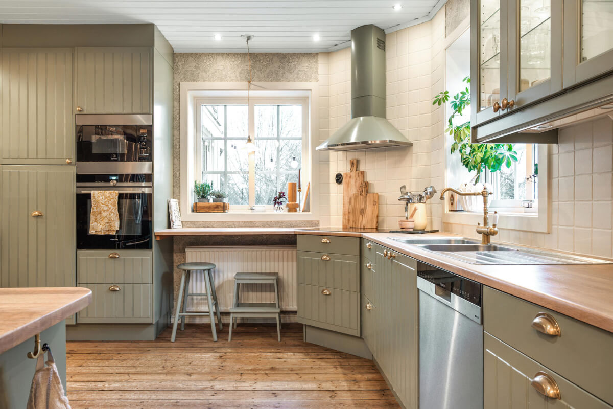 A Charming Home with Lake Views South of Stockholm 9 light green country kitchen bar seating under window