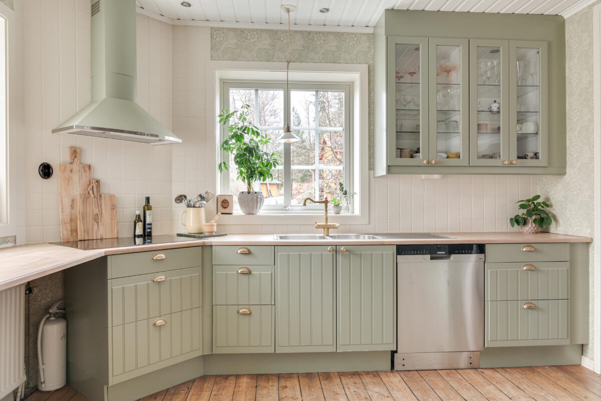 A Charming Home with Lake Views South of Stockholm 7 light green kitchen brass fittings