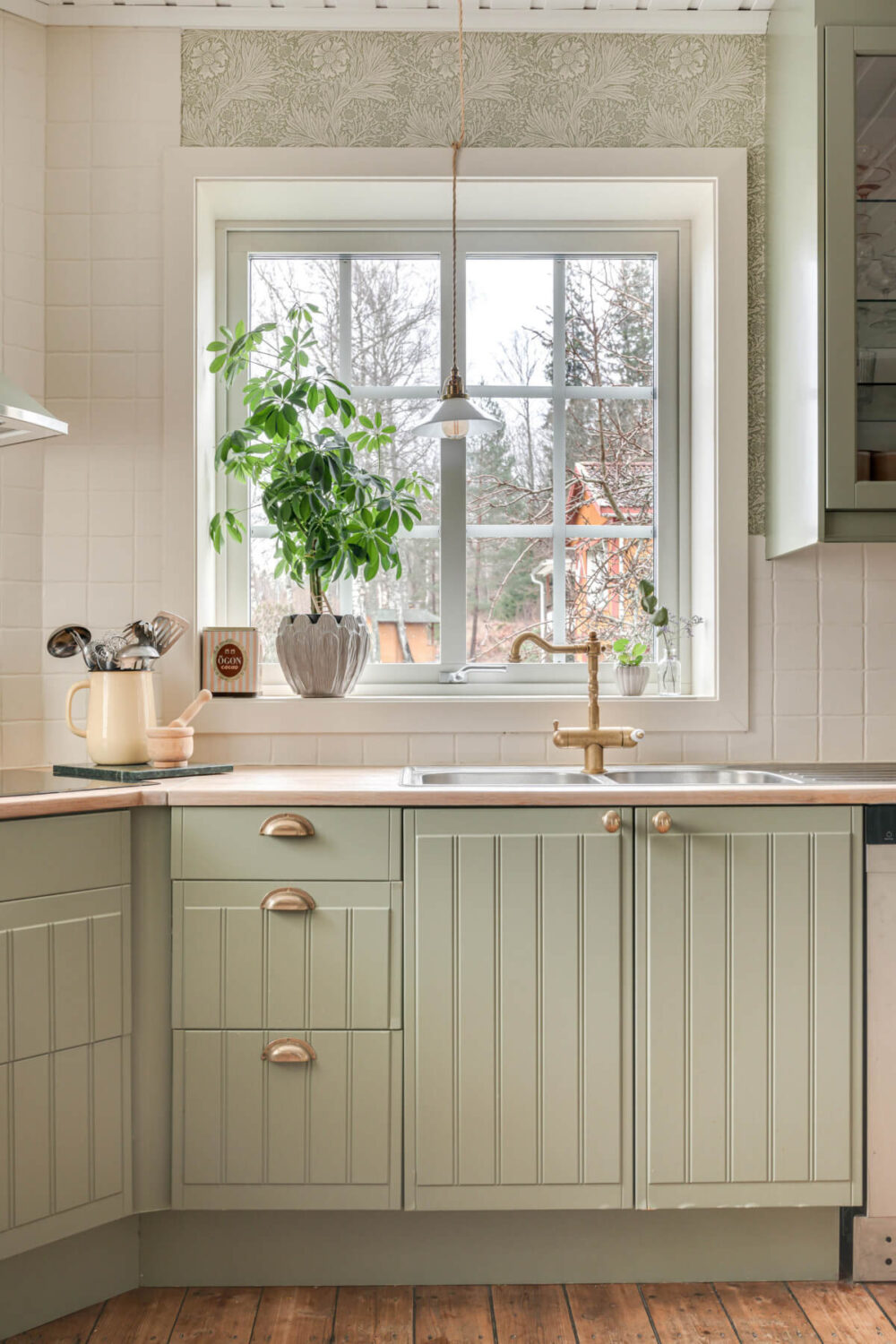 A Charming Home with Lake Views South of Stockholm 8 light green kitchen cabinets brass fittings