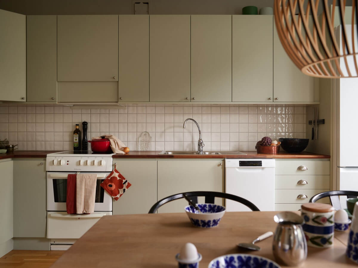 A Charming Two-Bedroom Corner Apartment in a 1940s Building 10 light green kitchen cabinets