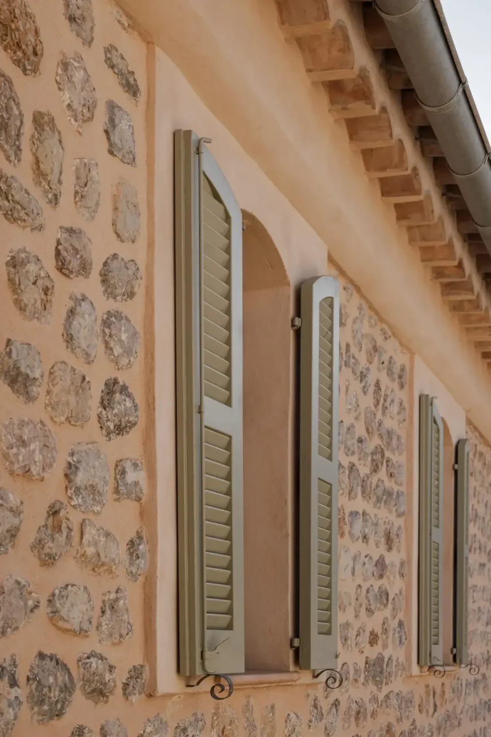 Old-World Craftsmanship and Contemporary Elegance in a Mallorcan Townhouse 14 light green shutters