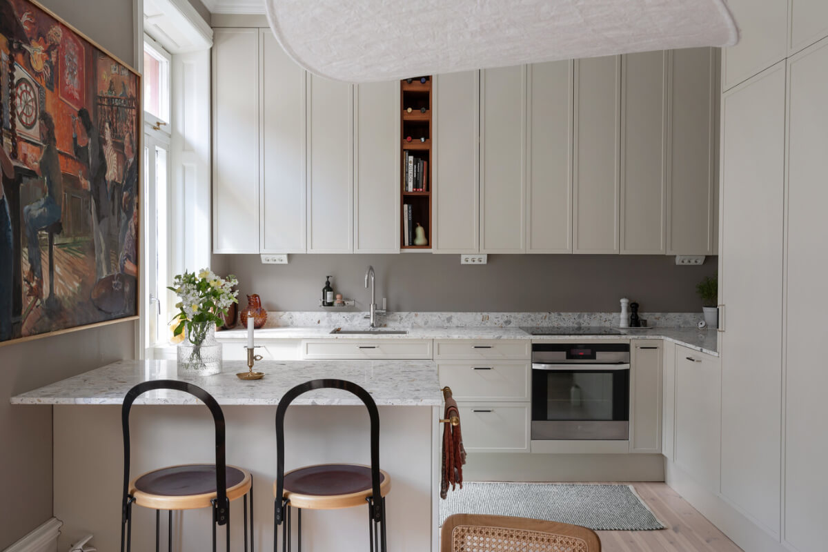 A Calm, Neutral Color Palette in a Classic Swedish Apartment 9 light kitchen cabinet to ceiling