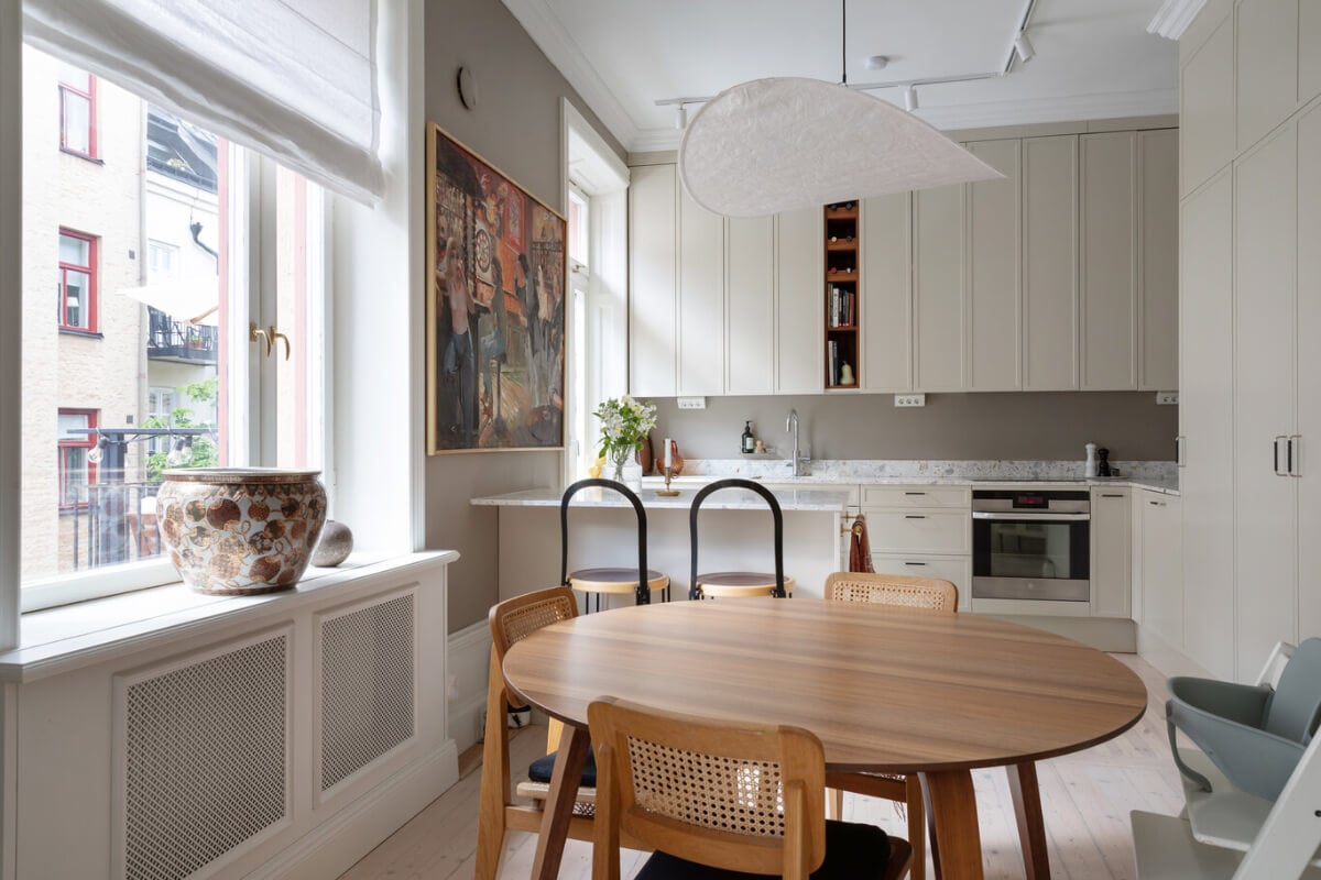 A Calm, Neutral Color Palette in a Classic Swedish Apartment 8 light kitchen space with round dining table