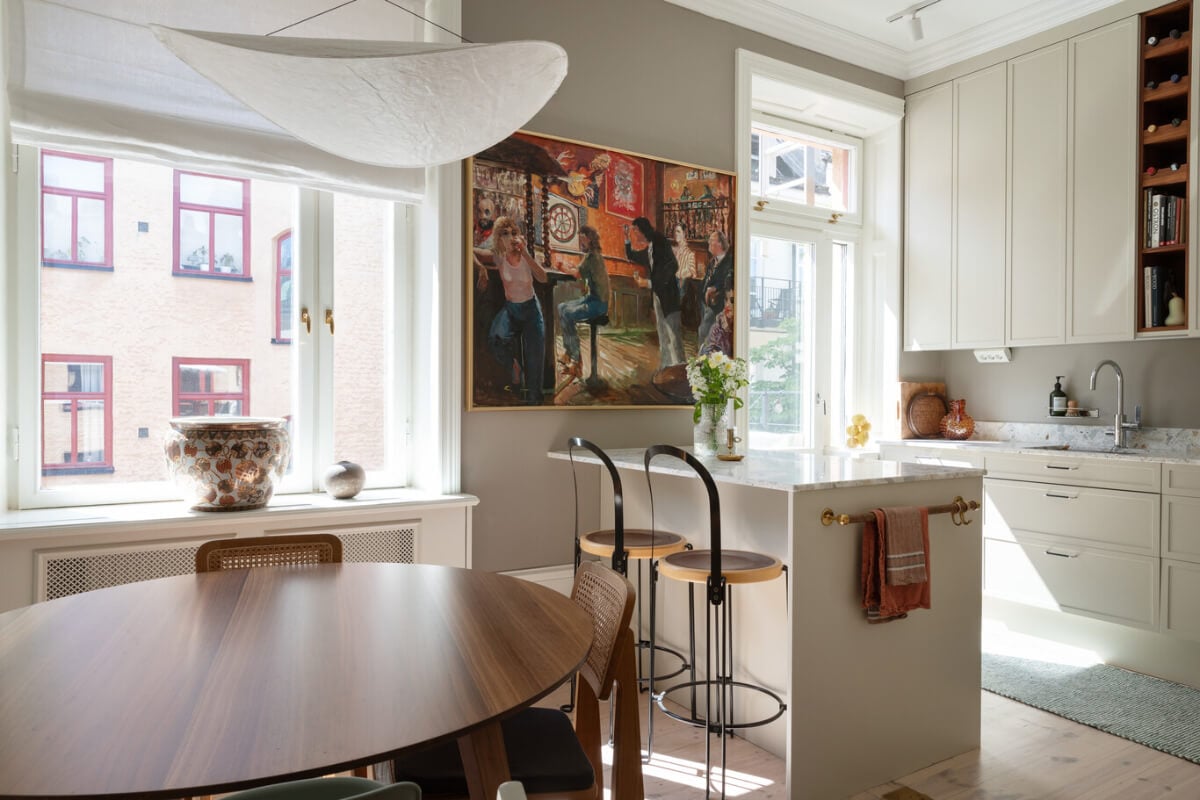 A Calm, Neutral Color Palette in a Classic Swedish Apartment 7 light kitchen with table and large artwork