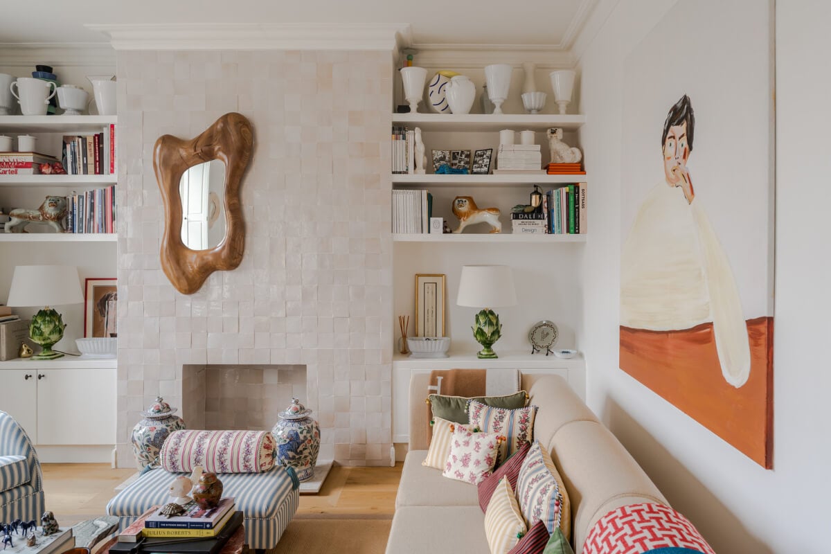 Cozy Contemporary Spaces in a Light-Filled Victorian Apartment 7 light living room floral patterned textiles zellige tiles fireplace mantel bookshelves