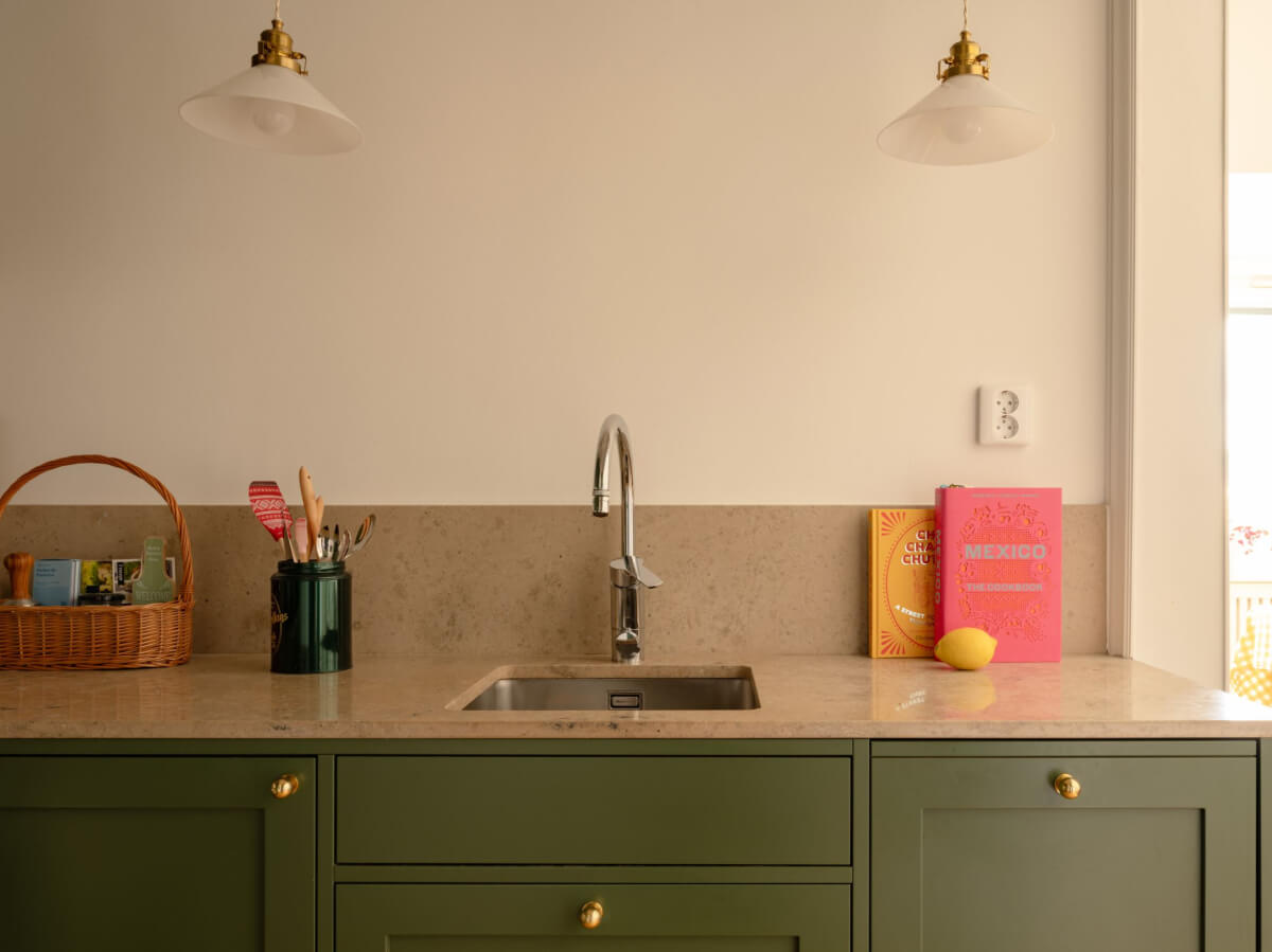A Small Apartment with High Ceilings and a Large Bay Window 20 limestone worktop green kitchen