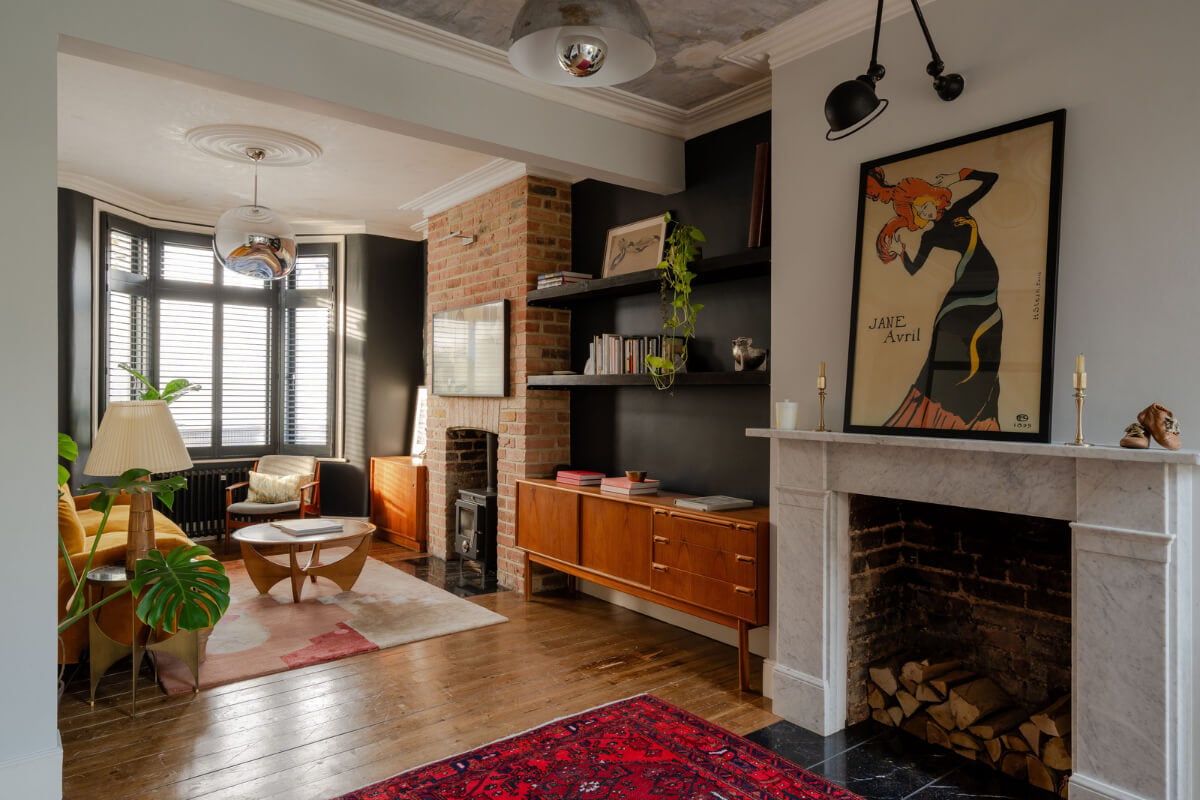 living room bay window black walls wooden floorboards fireplace